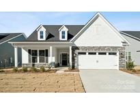 Craftsman style home with gray stone accents and a covered porch at 3118 Whispering Creek Dr, Indian Trail, NC 28079