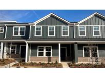 Charming townhome with a modern facade featuring a brick foundation and stylish white trim at 115 Ciara Pl # C, Mooresville, NC 28117