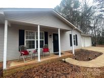 Ranch home with covered porch and attached garage at 136 Creek Branch Dr, Mooresville, NC 28115