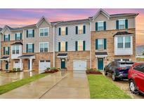 Modern three-story townhouses with attached garages and landscaped yards at 2608 Grantham Place Dr, Fort Mill, SC 29715