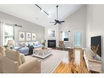 Bright and airy living room with vaulted ceilings and a cozy fireplace at 9311 Glenashley Dr, Cornelius, NC 28031