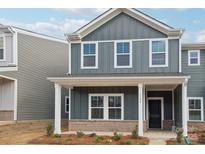 Gray siding, white trim, and a covered porch at 115 Ciara Pl # A, Mooresville, NC 28117