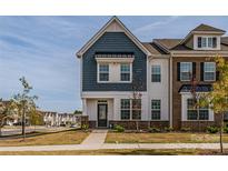 Two-story townhome with blue siding and brick accents at 13905 Castle Nook Dr, Charlotte, NC 28273