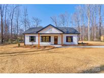 Charming one-story home with black shutters, wood porch supports and a well-manicured lawn at 1162 Scenic Cir, Shelby, NC 28150