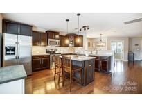 Modern kitchen with dark cabinets, stainless steel appliances, and island at 1964 Clear Brooke Dr, Kannapolis, NC 28083