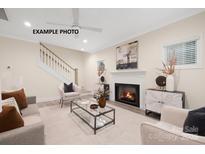 Bright living room features a fireplace and a view of the staircase at 1002 Fairground St, Charlotte, NC 28208