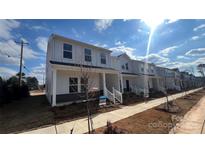 Modern white two-story home with covered porch and landscaping at 105 Ciara Pl # A, Mooresville, NC 28117