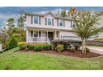 Two-story house with light pink siding, landscaping, and a two-car garage at 160 Hedgewood Dr, Mooresville, NC 28115