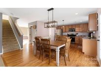 Bright kitchen with hardwood floors, light cabinets, and stainless steel appliances at 160 Hedgewood Dr, Mooresville, NC 28115