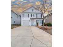 Two-story house with white siding, a driveway, and landscaping at 4126 Kellybrook Dr, Concord, NC 28025