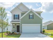 Two-story house with green siding, two-car garage, and landscaping at 1150 Red River Dr, Salisbury, NC 28144