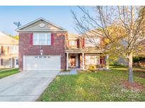 Charming two-story brick home with an attached two-car garage and manicured front yard at 2318 Sweet Flag Ct, Charlotte, NC 28262