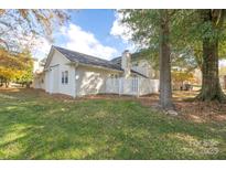 Charming home with a large backyard, mature trees, and white picket fence at 2702 New Hamlin Way, Charlotte, NC 28210