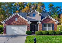 Charming brick home with a well-manicured lawn, attached garage, and inviting curb appeal in a desirable neighborhood at 639 Stonehenge Dr, Rock Hill, SC 29730