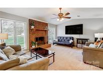 Spacious living room featuring a brick fireplace and large windows at 1500 Beth Haven Church Rd, Denver, NC 28037