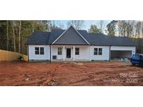 Charming one-story home featuring white siding, black roof, and a welcoming front porch at 536 Robinhood Rd # 27, Maiden, NC 28650