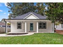 Charming craftsman style home with a covered porch and manicured lawn at 1905 Umstead St, Charlotte, NC 28205