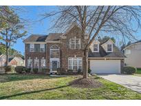 Brick two-story house with a large front yard and attached garage at 2240 Dunnwood Hills Dr, Matthews, NC 28105