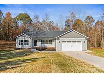 Charming single-story home with a two-car garage and a well-manicured lawn, all under a clear, sunny sky at 3146 Captains Cove Ln, Lincolnton, NC 28092
