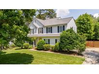 Charming two-story home with well-manicured lawn, mature trees, and classic shutters at 107 Monterey Dr, Mooresville, NC 28117