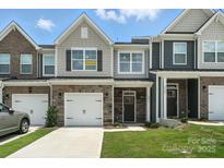 Charming townhome with stone accents, a one car garage, and craftsman style architecture at 6259 Tea Olive Dr # 178, Harrisburg, NC 28075