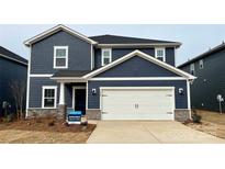 Two-story home with navy blue siding, white garage door, and landscaping at 106 Obadiah Ct, Troutman, NC 28115