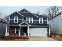 Charming two-story home with dark siding, white trim, and a two-car garage at 122 Satchel Ct, Troutman, NC 28115