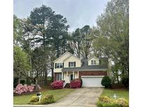 Charming two-story home boasts a brick-and-siding facade, manicured lawn, and flowering shrubs at 3195 Hadden Hall Blvd, Fort Mill, SC 29715
