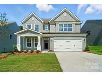 Charming two-story home with a well-manicured lawn and a two car garage at 5112 Heathland Dr # 75, Charlotte, NC 28215