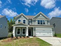 Charming two-story home with a two-car garage, tidy lawn, and welcoming front porch at 5112 Heathland Dr # 75, Charlotte, NC 28215
