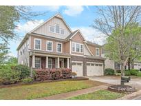 Charming two-story home features a manicured lawn, two-car garage, and inviting front porch at 8905 Valleymoon Ln, Charlotte, NC 28214