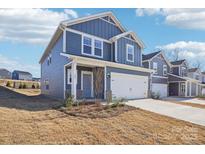 Charming two-story home with a blue exterior, attached two-car garage, and well-manicured lawn at 103 Obadiah Ct, Mooresville, NC 28115