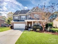 Charming two-story home features a two-car garage, well-manicured lawn, and lovely curb appeal at 2741 Smethwick Ln, Gastonia, NC 28056