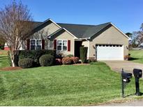 Charming one story home with manicured lawn, tasteful landscaping, and a two car garage at 120 W Edinburgh Ct, Statesville, NC 28625