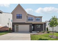 Two-story home featuring a brick facade, a two-car garage, and a manicured front lawn at 15008 Brownleigh Ln # 29, Huntersville, NC 28078