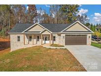 Charming one-story brick home with a two-car garage, inviting entryway, and freshly-laid driveway at 6249 Hayden Dr, Hickory, NC 28601