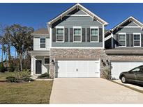 Two-story townhome with gray siding, stone accents, and a two-car garage at 4127 Steel Way, Sherrills Ford, NC 28673