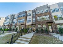 Townhome featuring a brick facade, modern design, and well-maintained landscaping at 544 Billingsley Rd, Charlotte, NC 28211