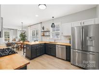 Bright open kitchen with stainless steel appliances and butcher block countertops at 8225 Ballymore Ct, Huntersville, NC 28078
