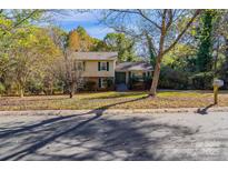 Ranch style home with mature trees and a well-maintained lawn at 3316 Valley Grove Rd, Charlotte, NC 28227