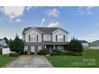 Charming two-story home with landscaped yard and welcoming entrance at 125 Mallory Tai Dr, Lincolnton, NC 28092