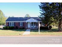 Brick ranch home with a well-maintained lawn and walkway at 150 Wilson St, Chester, SC 29706