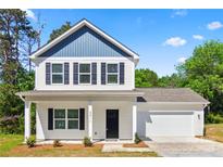 Beautiful two-story home with a well-maintained yard, a garage, and classic curb appeal at 2411 Datsun Ave, Concord, NC 28027