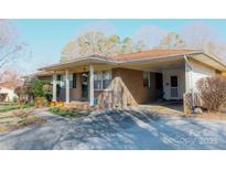 Charming single-story brick home featuring a covered front porch and a convenient carport at 907 Vista Dr, Cherryville, NC 28021