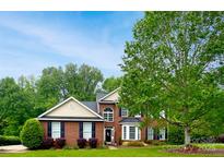 Charming brick two-story home with manicured lawn and lush landscaping showcasing curb appeal at 9618 Belloak Ln, Waxhaw, NC 28173