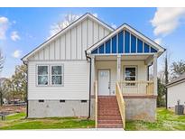 Charming new construction home featuring vertical siding, a covered porch and brick stairs at 1105 Kenly St, Salisbury, NC 28144