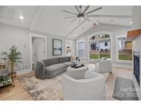 Cozy living room with vaulted ceiling, fireplace, and access to backyard at 1320 Brook Rd, Charlotte, NC 28205