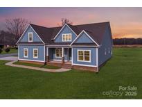 Two-story house with blue siding, brown roof, and a front porch at 220 W Lawyers Rd, Monroe, NC 28110