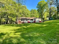 Charming single-story home with flowering shrubs and lush green lawn at 2109 Rock Springs Cir, Denver, NC 28037