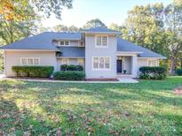 Charming home with a well-maintained lawn and mature trees providing shade at 8468 Blades Trl, Denver, NC 28037